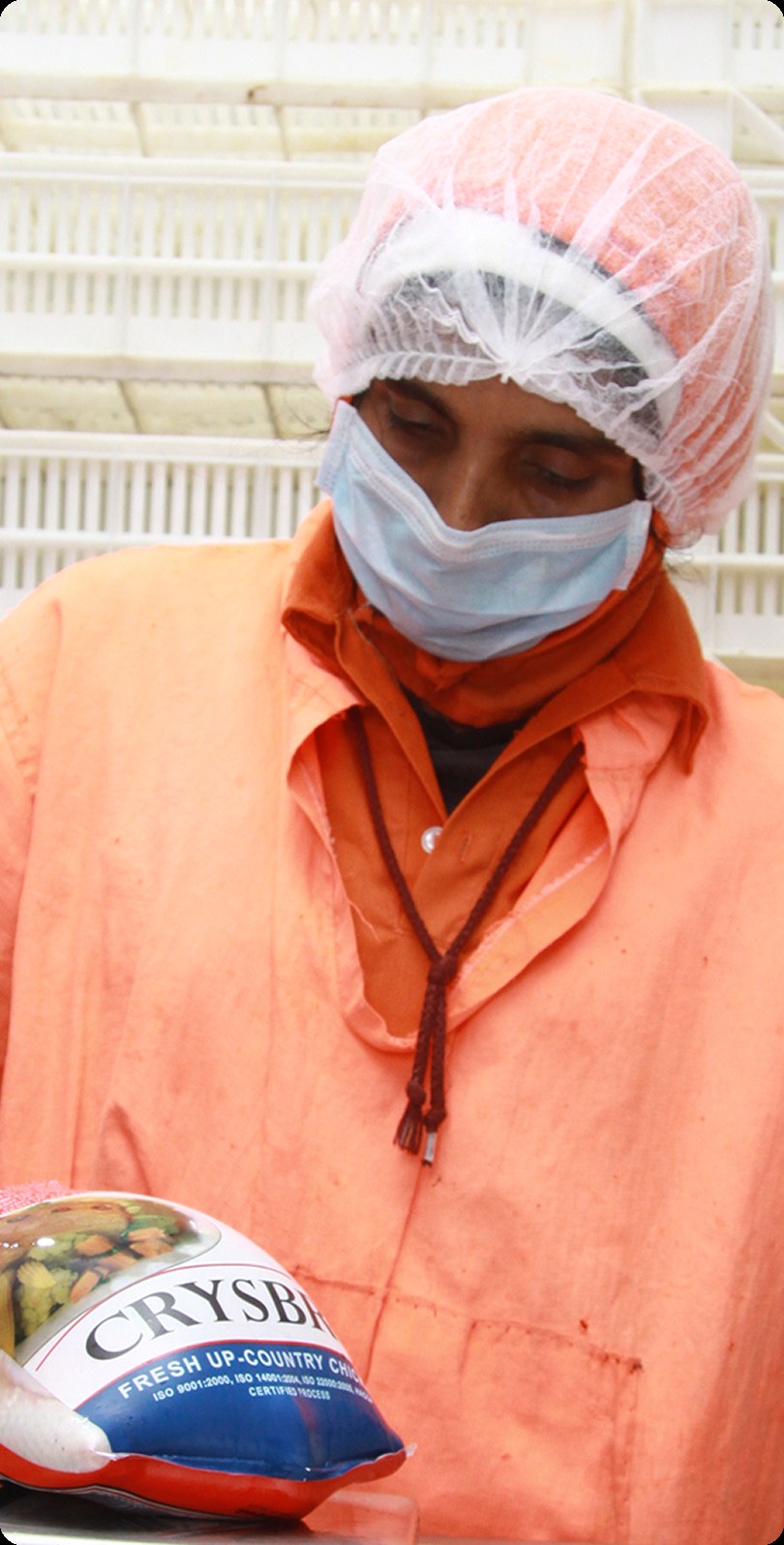 Crysbro quality-control technician weighing a packaged chicken